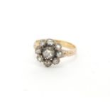 Unmarked gold diamond flower head ring, housed in a leather box, size K, approximate weight 2.3g :