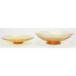 Two Whitefriars tangerine glass dishes including a footed ribbon example designed by Tom Hill, the