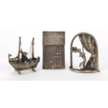 Silver objects, ballerina, fishing boat and house plaque, the largest 5cm high, approximate weight