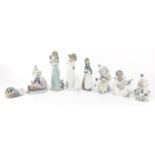 Lladro and Nao including three clowns and a girl holding a pig, the largest 21cm high : For