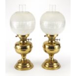 Pair of brass oil lamps with floral etched glass shades, 51.5cm high : For further Condition Reports