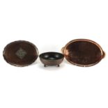 Two Arts & Crafts copper trays and a Dryad Lester three footed bowl, the trays comprising a