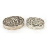 Two oval continental silver snuff boxes, the hinged lids embossed with working children and