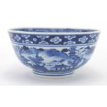 Chinese blue and white porcelain bowl, hand painted with a continuous river landscape and Prunus
