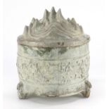 Chinese three footed pottery jar and cover, decorated in relief with a continuous band of mythical