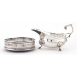 Silver three footed sauce boat and circular silver wine coaster, with pierced gallery, the boat E.