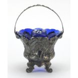 French silver basket embossed with flowers, with swing handle and blue glass liner, indistinct