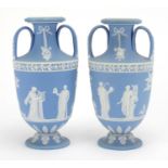 Pair of Wedgwood Jasperware urn vases, with twin handles, each decorated in low relief with a