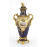 19th century Coalport four footed porcelain vase and cover, with twin handles, hand painted and