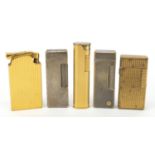 Five lighters comprising two gold plated Dunhill, two silver plated Dunhill and musical Flamsong :