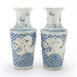 Pair of Chinese blue and white porcelain vases, each hand painted and decorated in relief with a