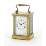 Miniature brass cased carriage clock with enamelled dial and Roman numerals, 9cm high : For extra