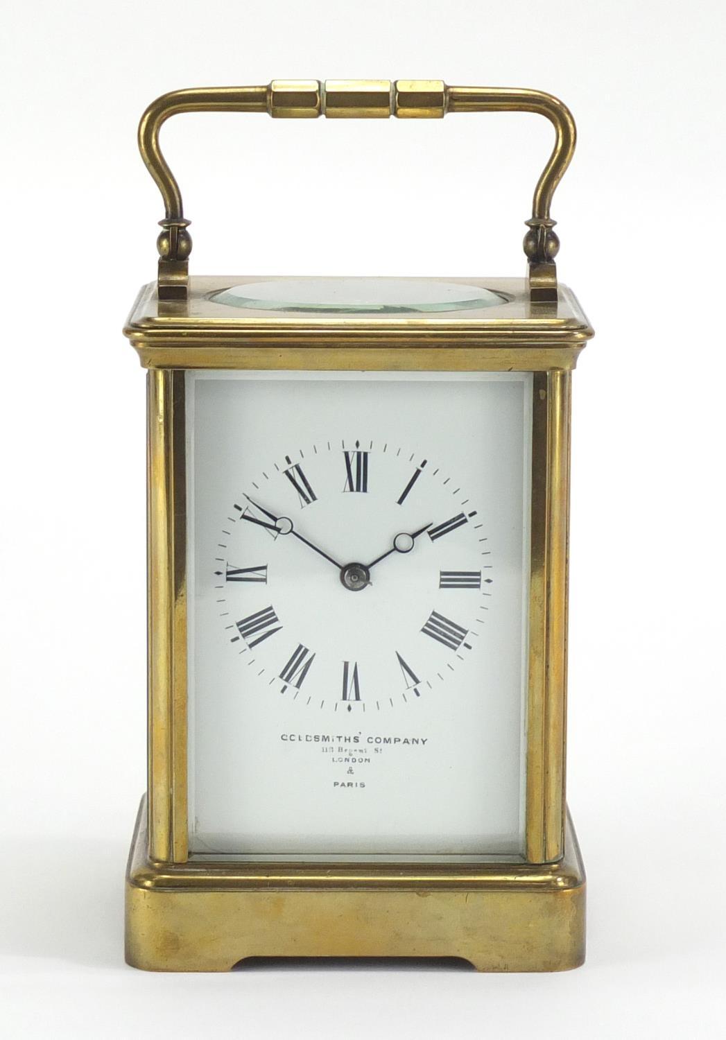 Brass cased carriage clock by Goldsmiths Company London and Paris, with enamelled dial and Roman - Image 2 of 6