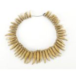 Tribal tooth necklace : For extra condition reports please visit www.eastbourneauction.com