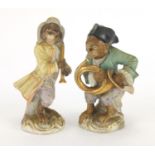 Pair of continental hand painted porcelain monkey band figures, factory marks to the bases, the