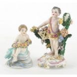 Two hand painted continental porcelain figures of cupids with garlands of flowers including a Samson