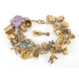 9ct gold charm bracelet with a selection of mostly 9ct gold charms, animals, Jersey Cream can,