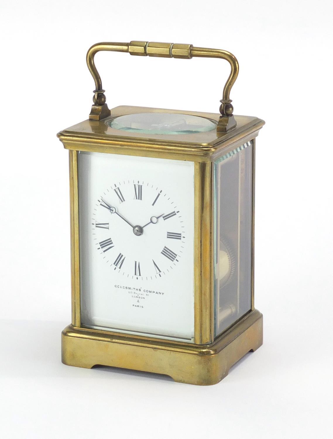 Brass cased carriage clock by Goldsmiths Company London and Paris, with enamelled dial and Roman