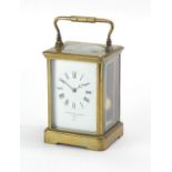 Brass cased carriage clock by Goldsmiths Company London and Paris, with enamelled dial and Roman