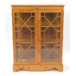 Pine display cabinet fitted with a pair of glazed doors two adjustable shelves, 124cm H x 94cm W x