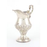 Victorian silver pedestal cream jug, with demi fluted body, C.S.H London 1894, 12cm high,