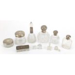 Seven silver mounted cut glass scent bottles, jars and powder pots, some with embossed decoration,