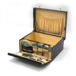 Drew & Sons of Piccadilly Leather vanity case with silver and guilloche enamelled accessories,