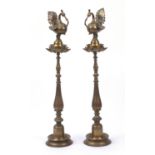 Pair of Middle Eastern floor standing brass oil burners, each 95cm high : For Further Condition