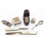 Silver objects and two thimbles, one housed in a velvet lined leather case comprising chatelaine