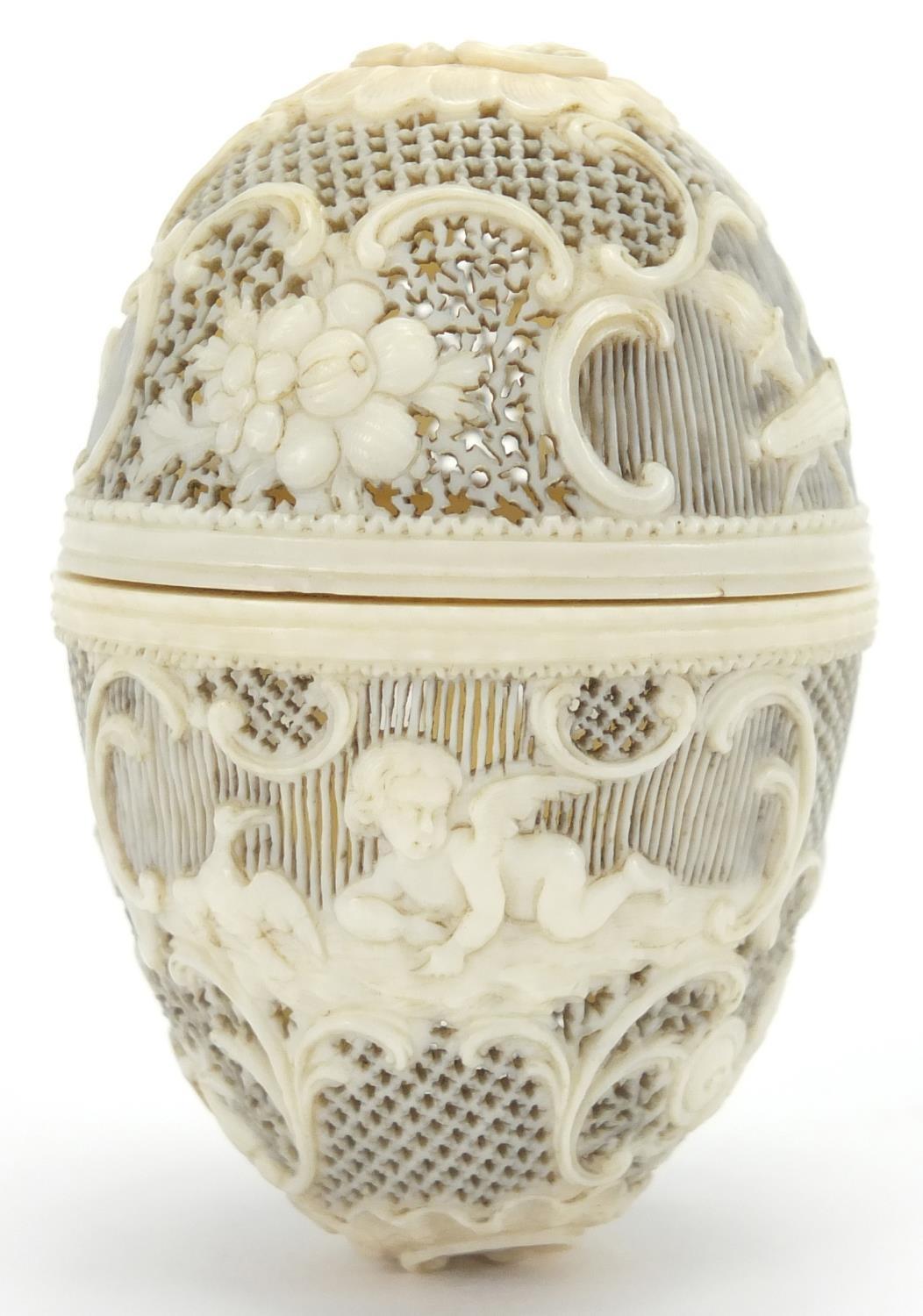 19th century European ivory trinket, finely pierced and carved with Cupids and flowers amongst C