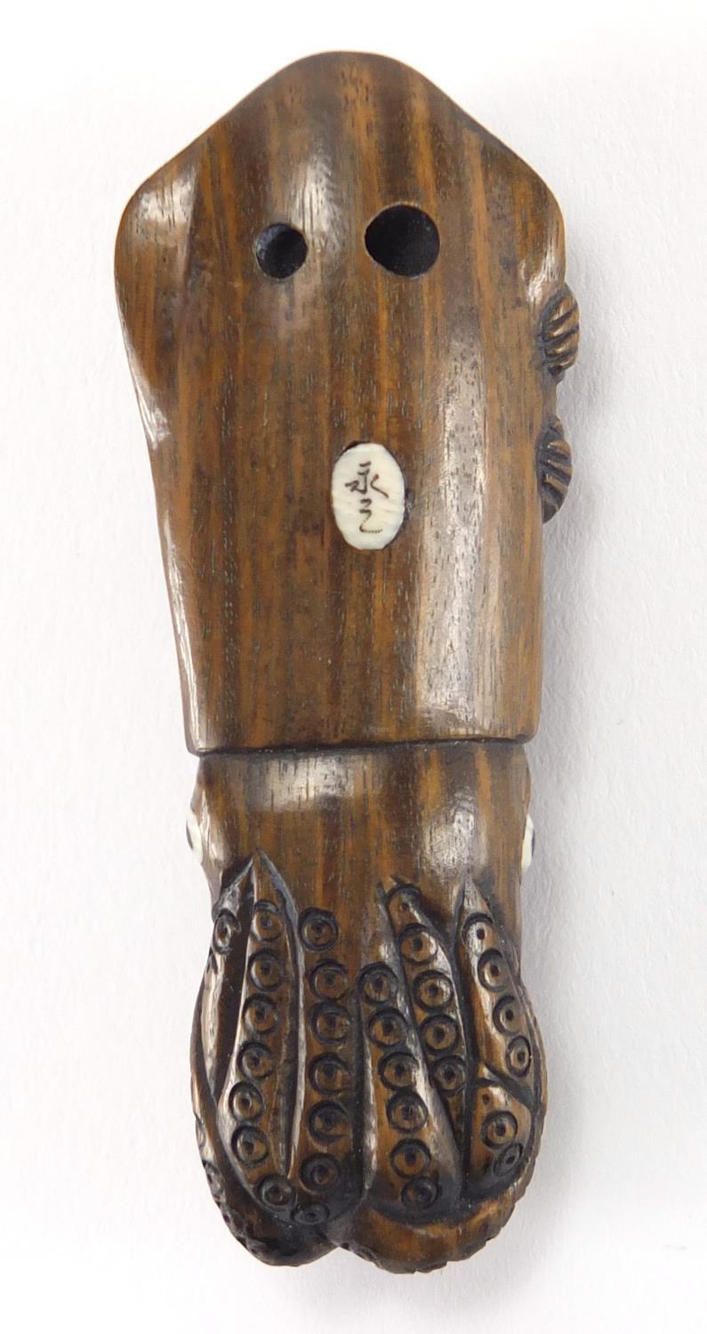 Japanese carved hardwood Netsuke of a female sleeping upon an octopus, with inset ivory character - Image 2 of 5