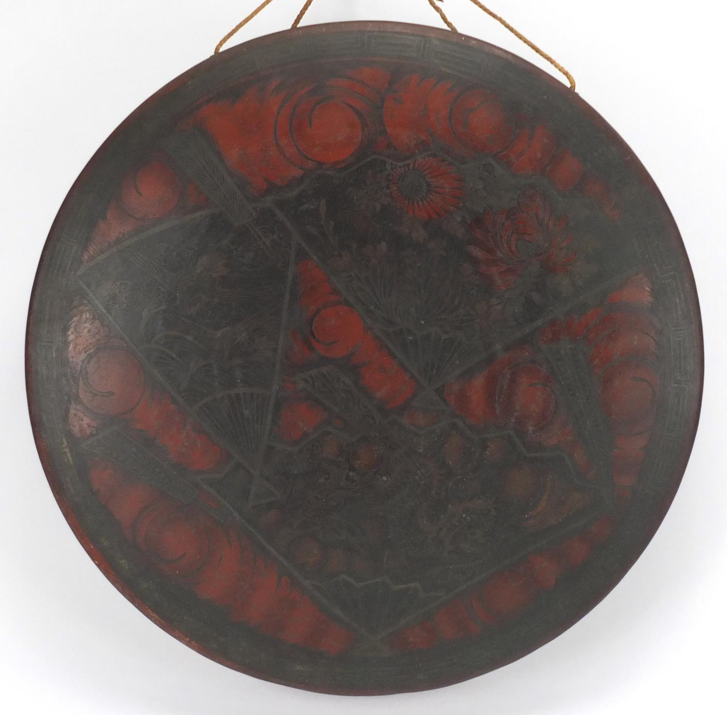 Oriental red lacquered bronze gong, with fan shaped panels of flowers, 40cm in diameter : For