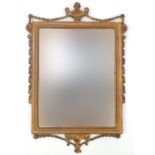 Ornate gilt framed bevelled mirror, with urn and swag design, 71cm x 45cm : For Further Condition