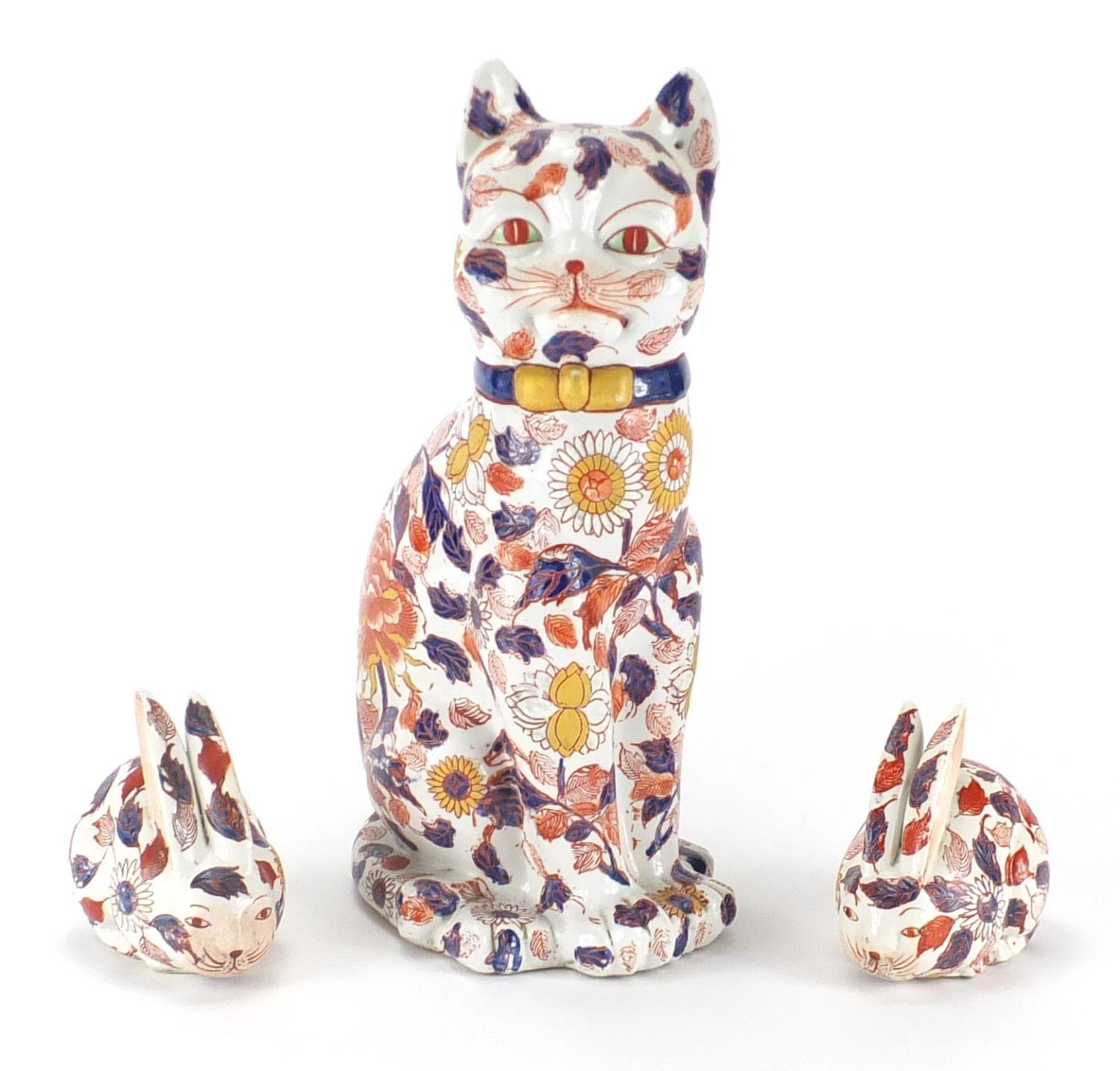 Japanese Imari cat and pair of rabbits, character marks to the bases, the largest 35cm high : For