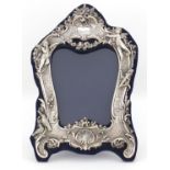 Modern silver easel photo frame, relief decorated with cupids and birds amongst flowers, 31cm high :