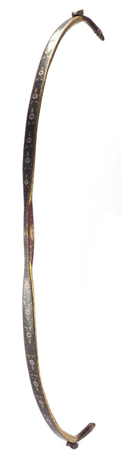 Ottoman lacquered hunting bow of curved form, finely hand painted and gilded with flowers, 89cm in