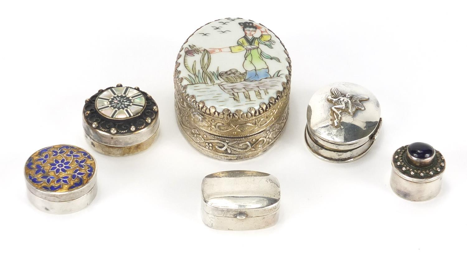 Five silver pill boxes and an Oriental silvered metal trinket, with porcelain panel, the largest 6cm