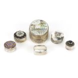 Five silver pill boxes and an Oriental silvered metal trinket, with porcelain panel, the largest 6cm