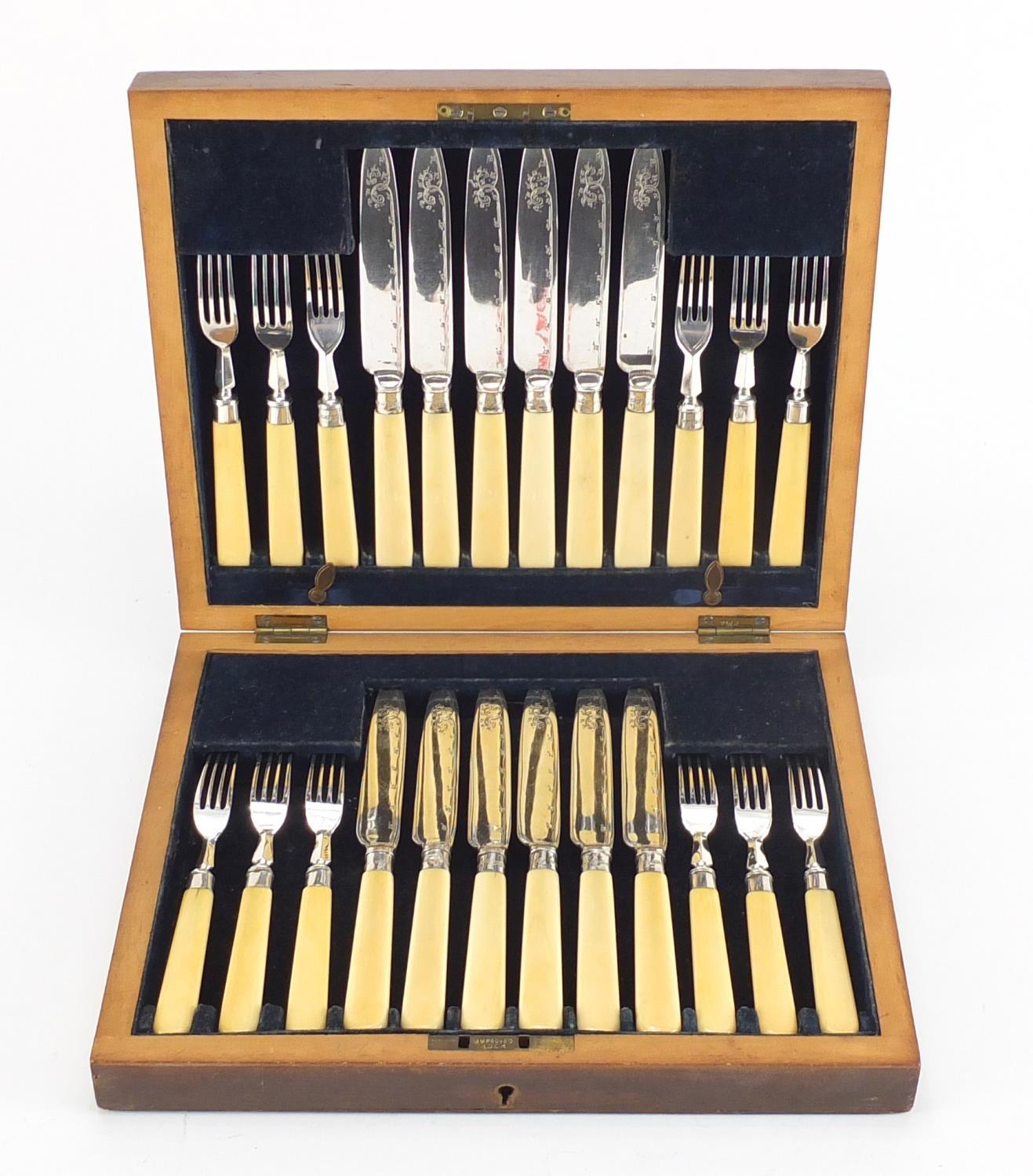 Mahogany six place canteen of silver plated fish knives and forks, with ivory handles and silver