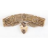 9ct gold six row gate bracelet with love heart shaped padlock, 20cm in length, approximate weight