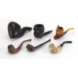 Five antique and later pipes including including a Blackamoors head and Meerschaum example with