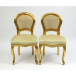 Pair of French gilt occasional chairs, with cane backs and stuff over seats, 82cm high : For Further
