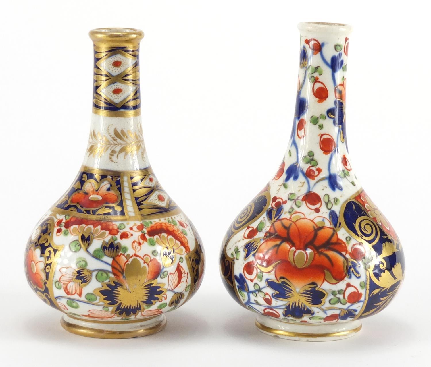 Two 19th century Derby porcelain bottle vases, hand painted and gilded in the Imari palette, painted