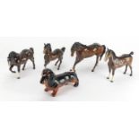 Four Beswick horses and a Dachshund, the largest 17.5cm high : For Further Condition Reports