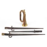 Three Military interest bayonets and a copper and brass bugle with Royal Welsh Fusilier badge,