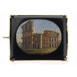 Italian micro mosaic brooch, depicting the Colosseum Rome, with unmarked gold mount, 3.4cm wide :For