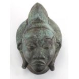 Patinated brass face mask of an Afrcian female's head, 36cm high : For Further Condition Reports