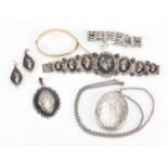 Silver and white metal jewellery including a large locket with floral chased decoration and a Siam