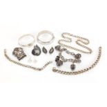 Silver and white metal jewellery including charm bracelet, curb link necklaces and bangles with