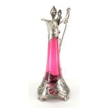 Art Nouveau pewter and cranberry glass lined ewer in the style of WMF, the pewter body cast with a